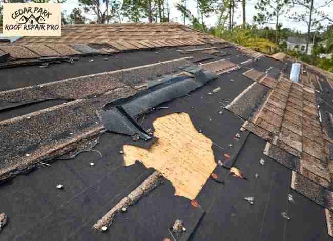 Storm-damaged commercial roof with missing shingles